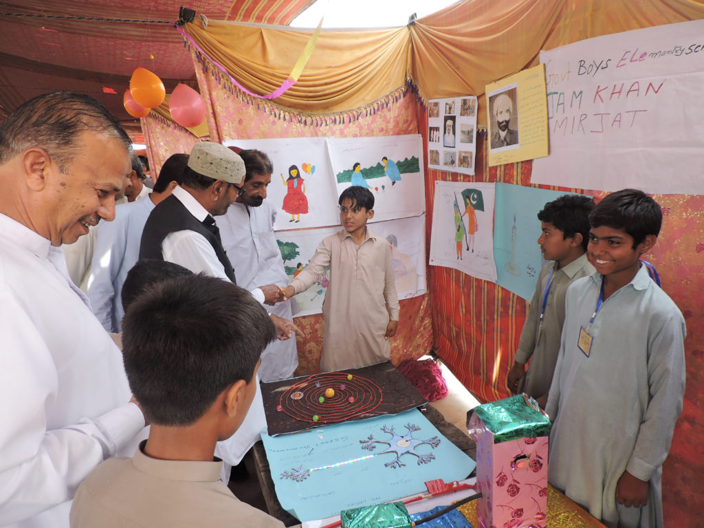 Students explain their projects to visitors at the CMP-organized Education Fairs in Jacobabad District