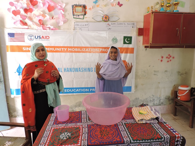 A CMP staff member conducts a handwashing demonstration for students in Kashmore