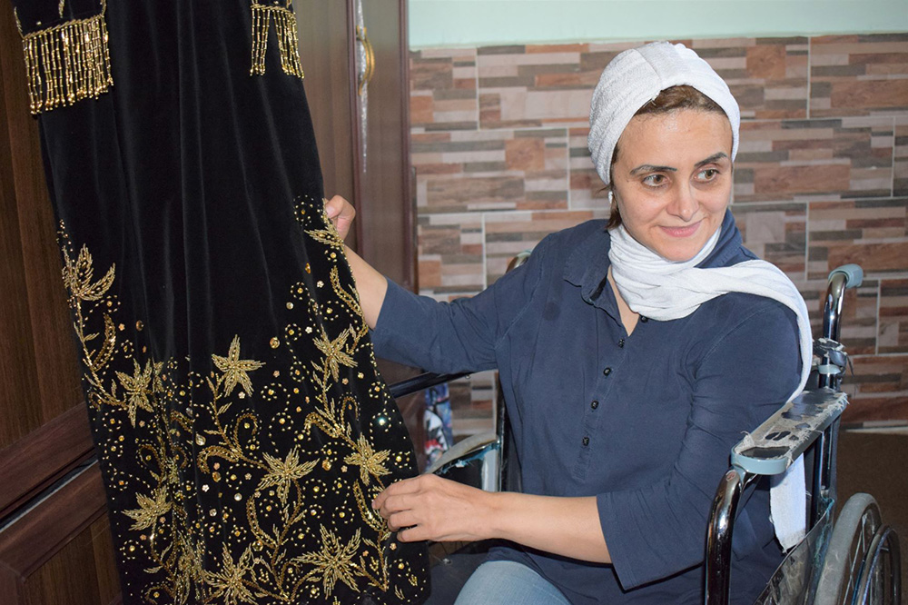 Yasmien, a Jordanian home-based business owner, with her embroidery work