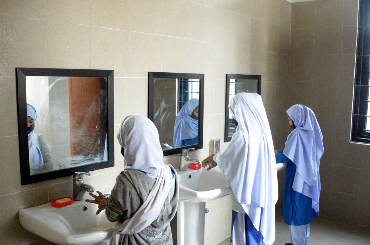 girls washing hands in bathroom funded by grants