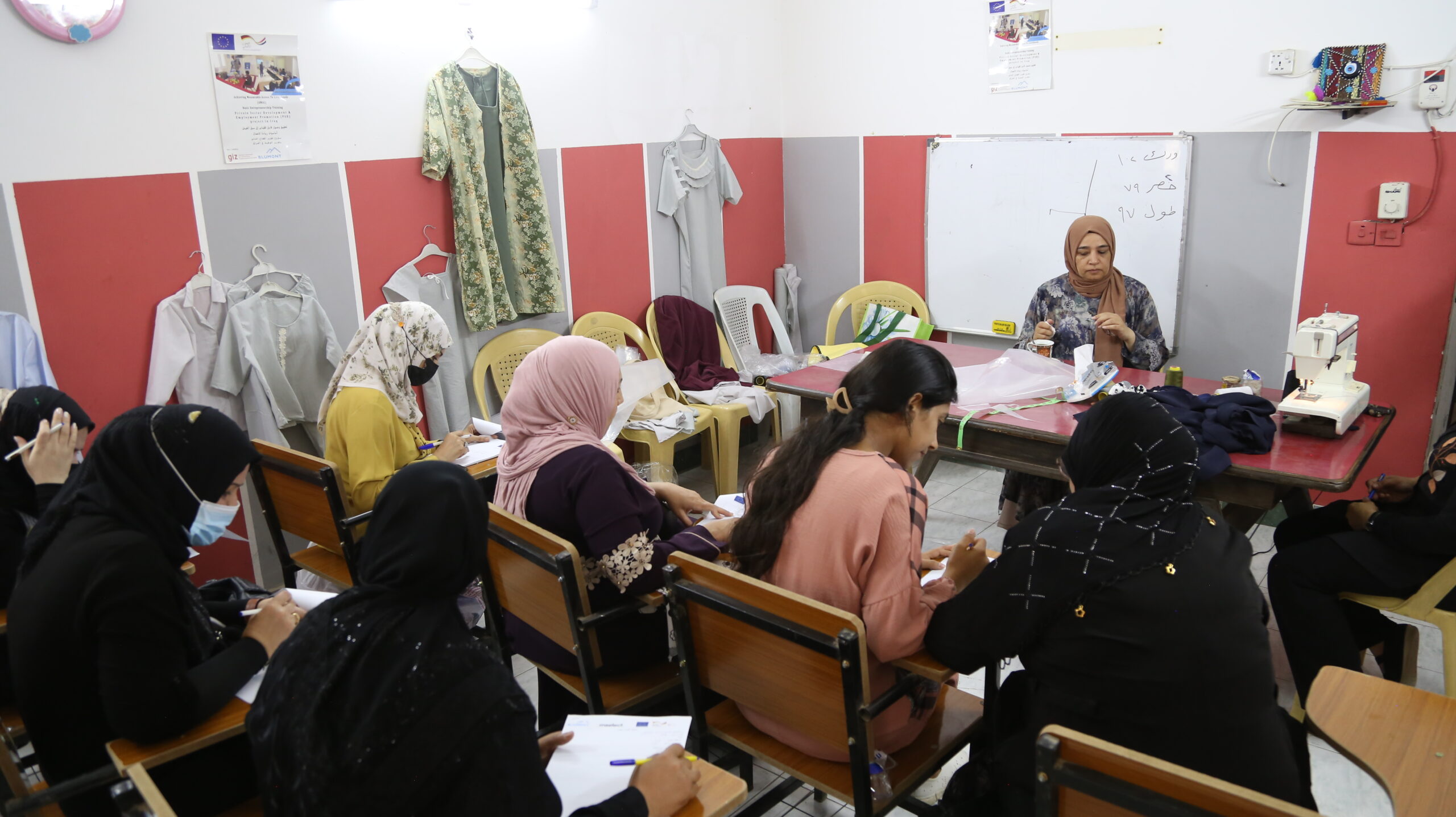 women in a classroom learning to sew