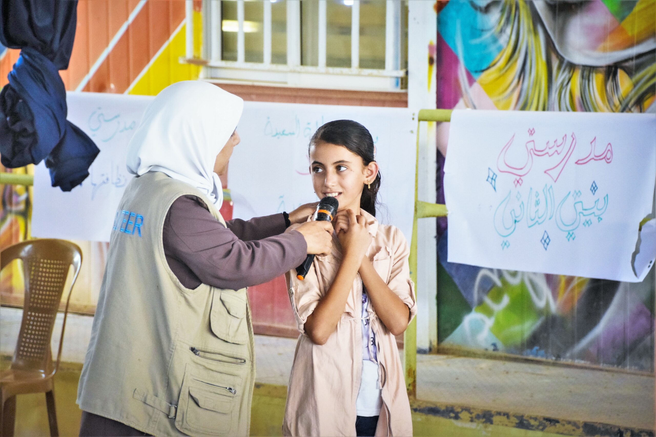 Woman holding microphone for girl