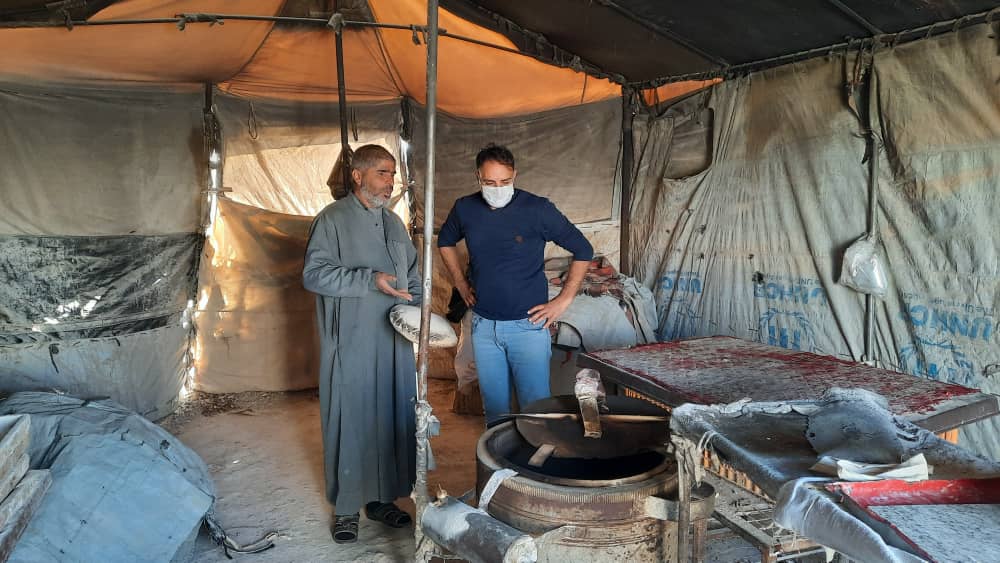 Anwar opened a bakery in his tent in a NE Syria displacement camp, where he sells bread and other baked goods to his neighbors.