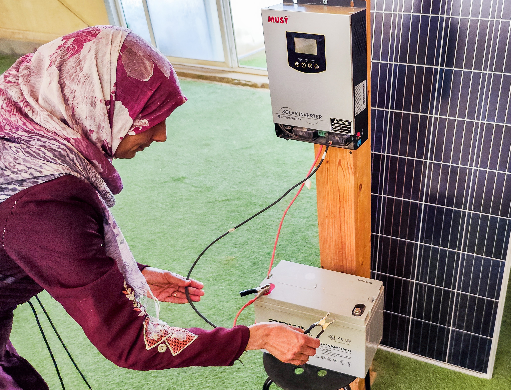 woman fixing solar energy panel system