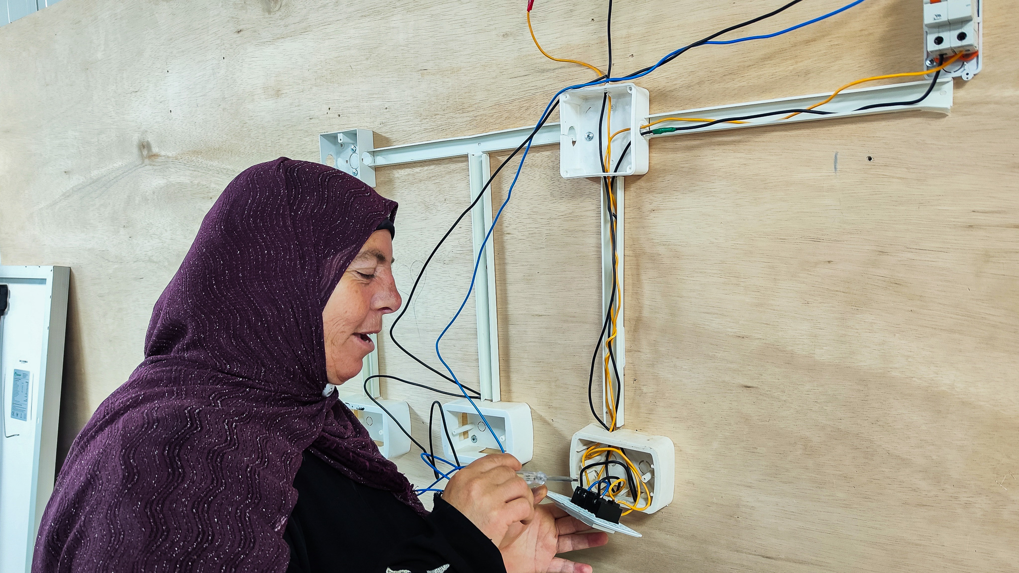 woman fixing solar panel system