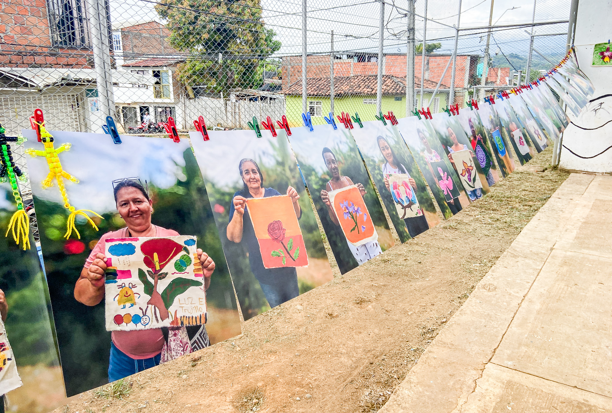 photos of Colombian women holding paintings of flowers
