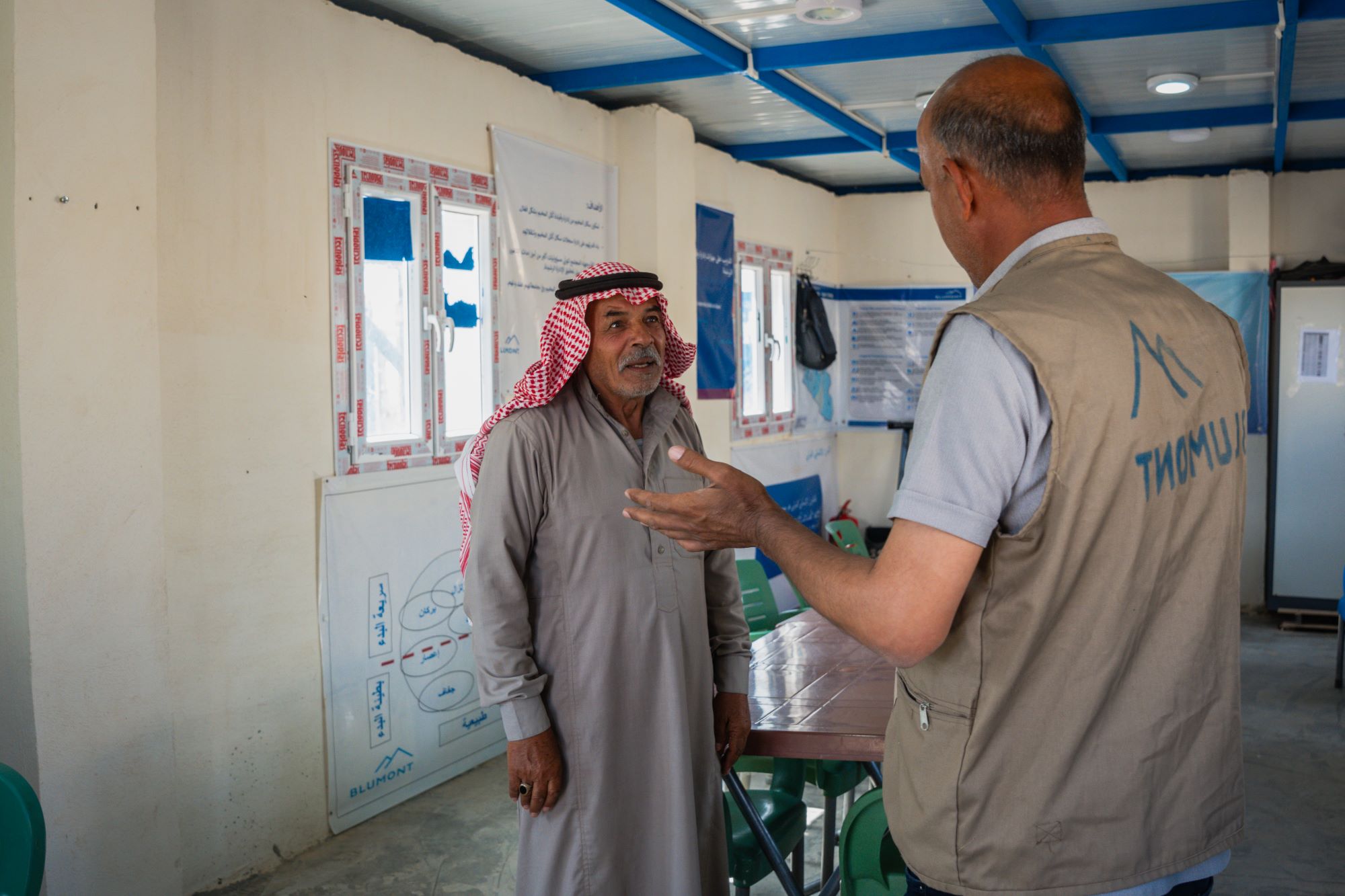 a staff member speaking with an older man